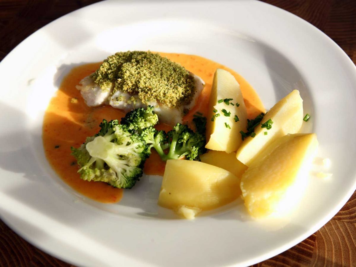 Hejk s bylinkovou krustou, omáčkou z červených paprik, brokolicí a vařeným bramborem